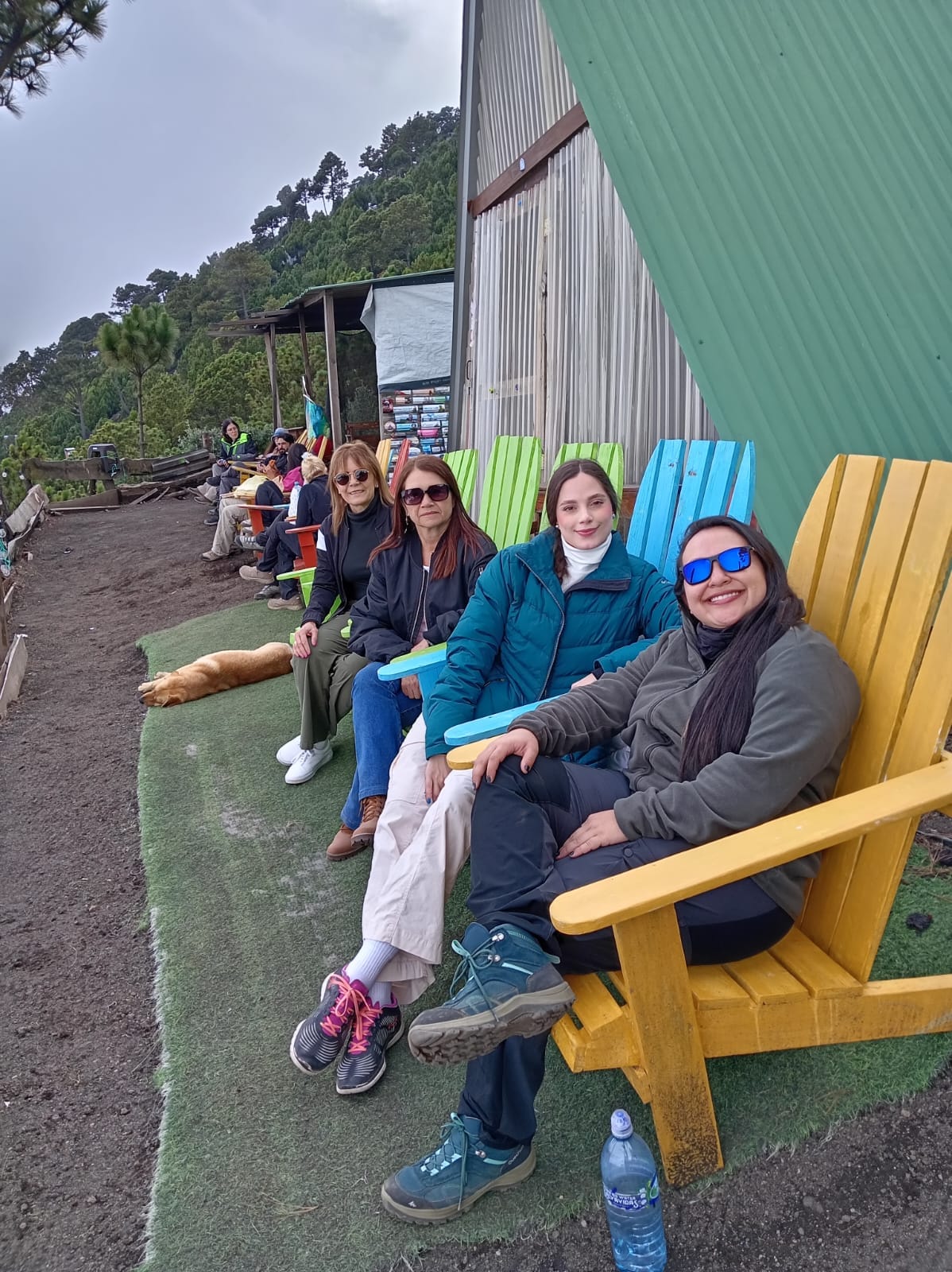 Travelers relaxing on colorful chairs at the base camp